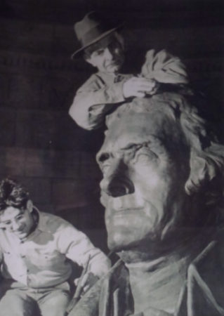 Attilio Contini and his son James apply a bronze patina to the plaster cast of the Thomas Jefferson in the memorial in Washington, D.C. Due to the war demand for rare metals, a plaster copy of the statue was installed by Attilio for the dedication of the memorial in 1943. The plaster remained in place until Attilio removed it in 1947 and it was replaced by the bronze statue seen today.